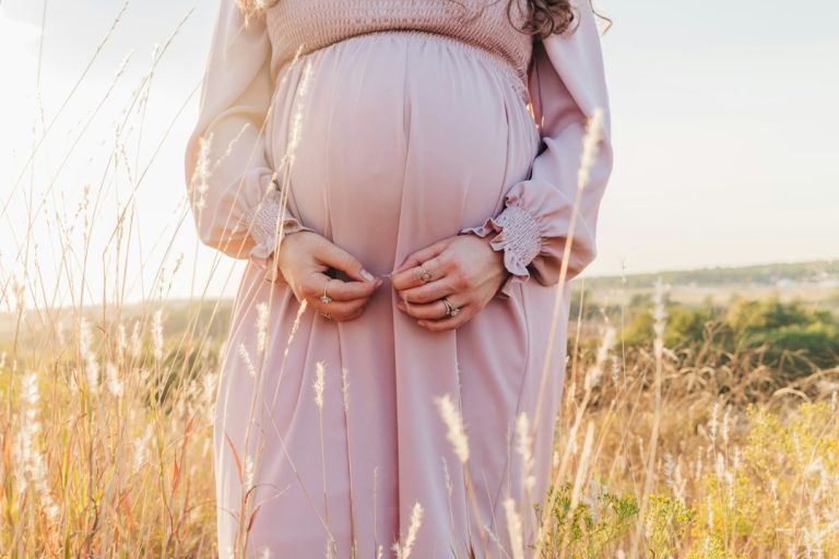Pregnant woman outdoors in warm evening light